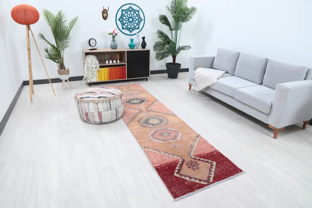 Overhead view of the vintage runner rug in a room, showing its length and colors