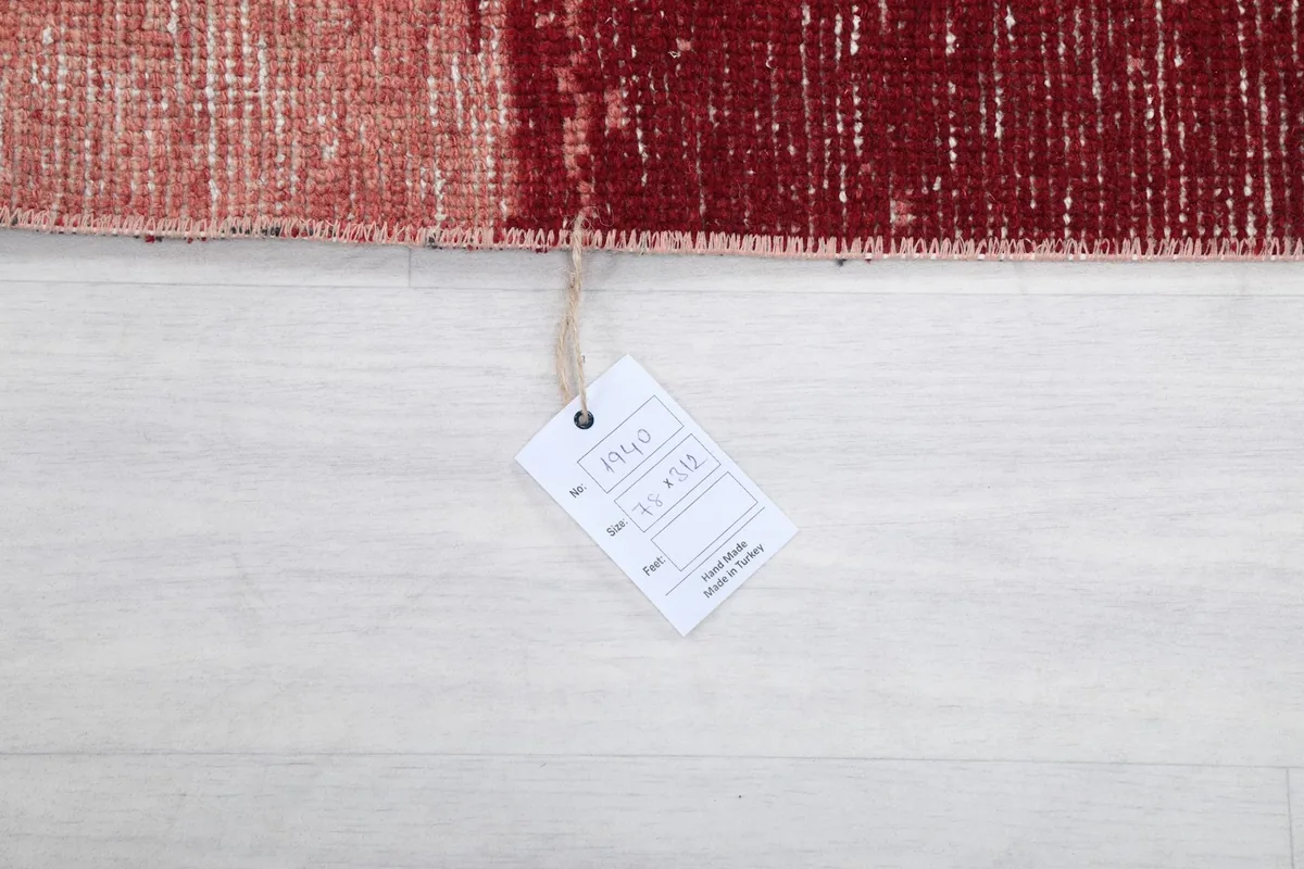 Product tag attached to the vintage runner rug, showing item details