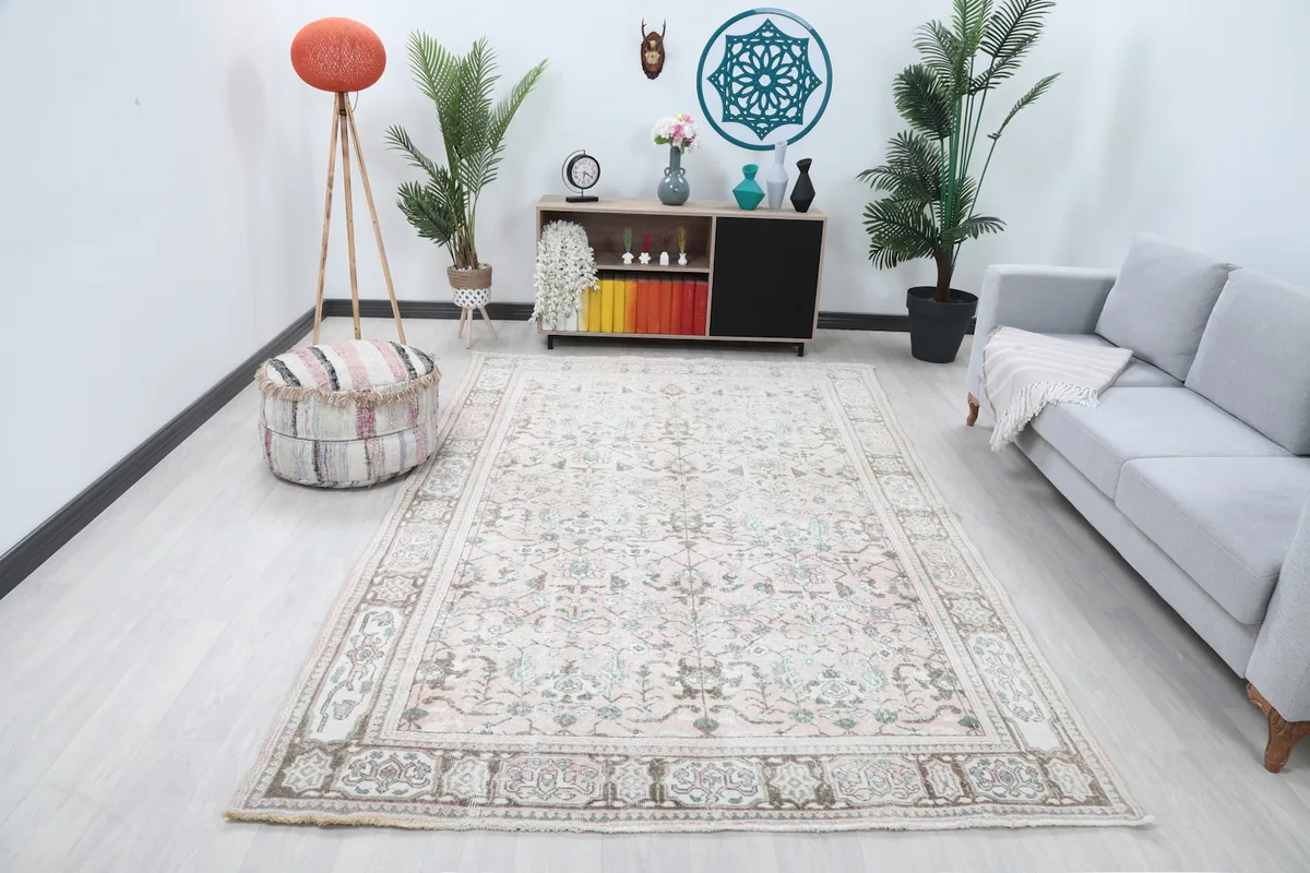 Vintage rose Anatolian rug displayed in a bright living room setting