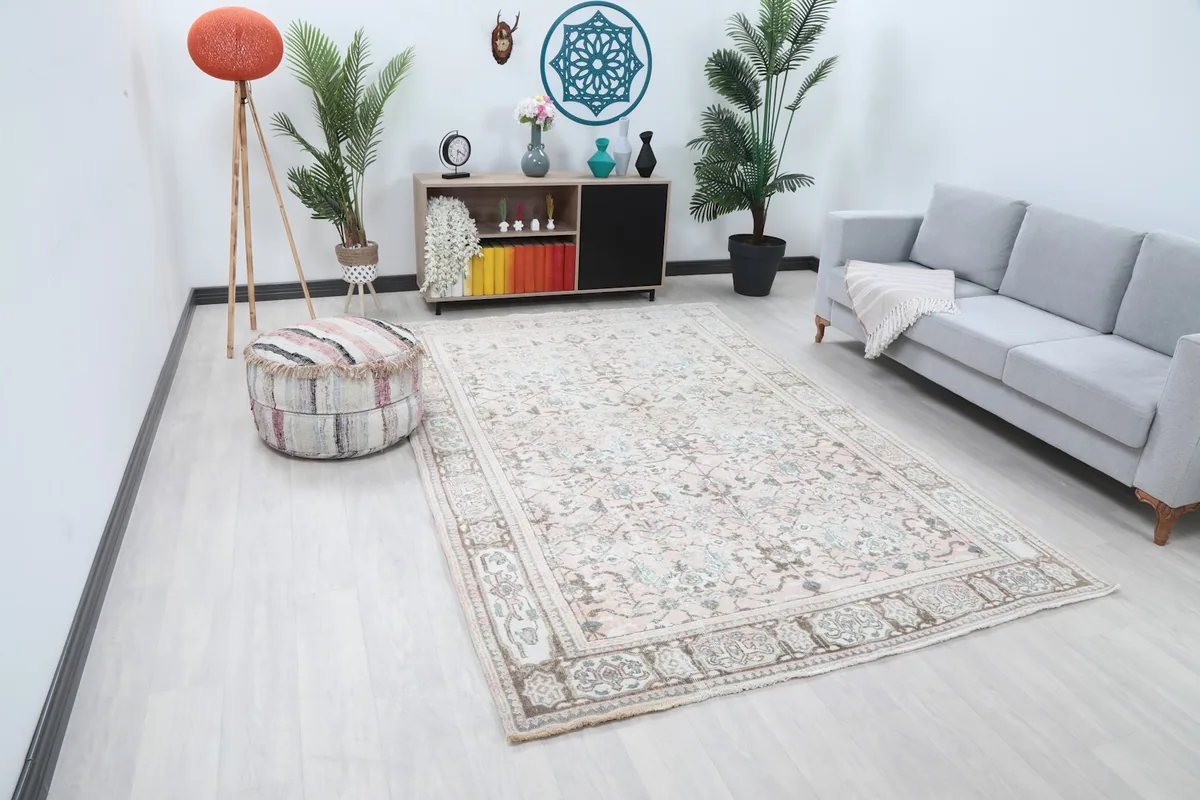 Angle view of the rose and beige vintage rug in a modern living space