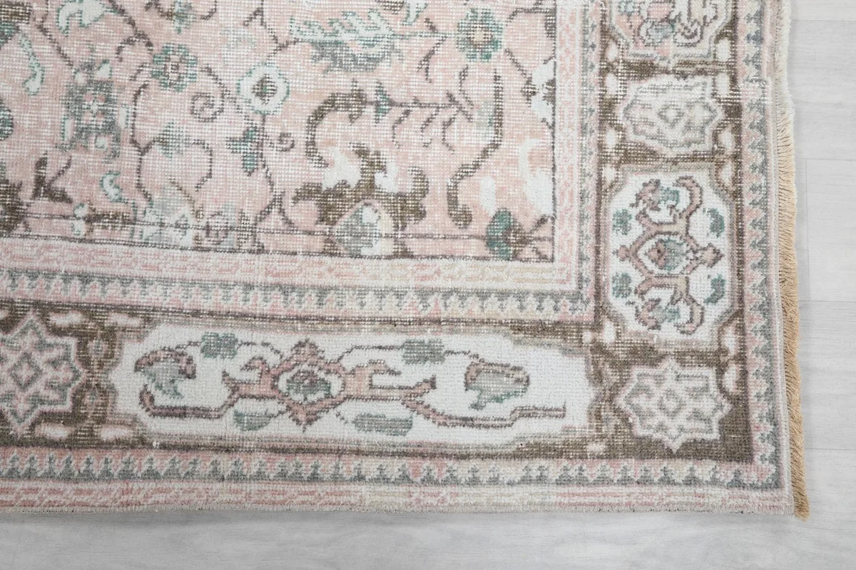 Detail of the outer border and corner design of the rose vintage rug