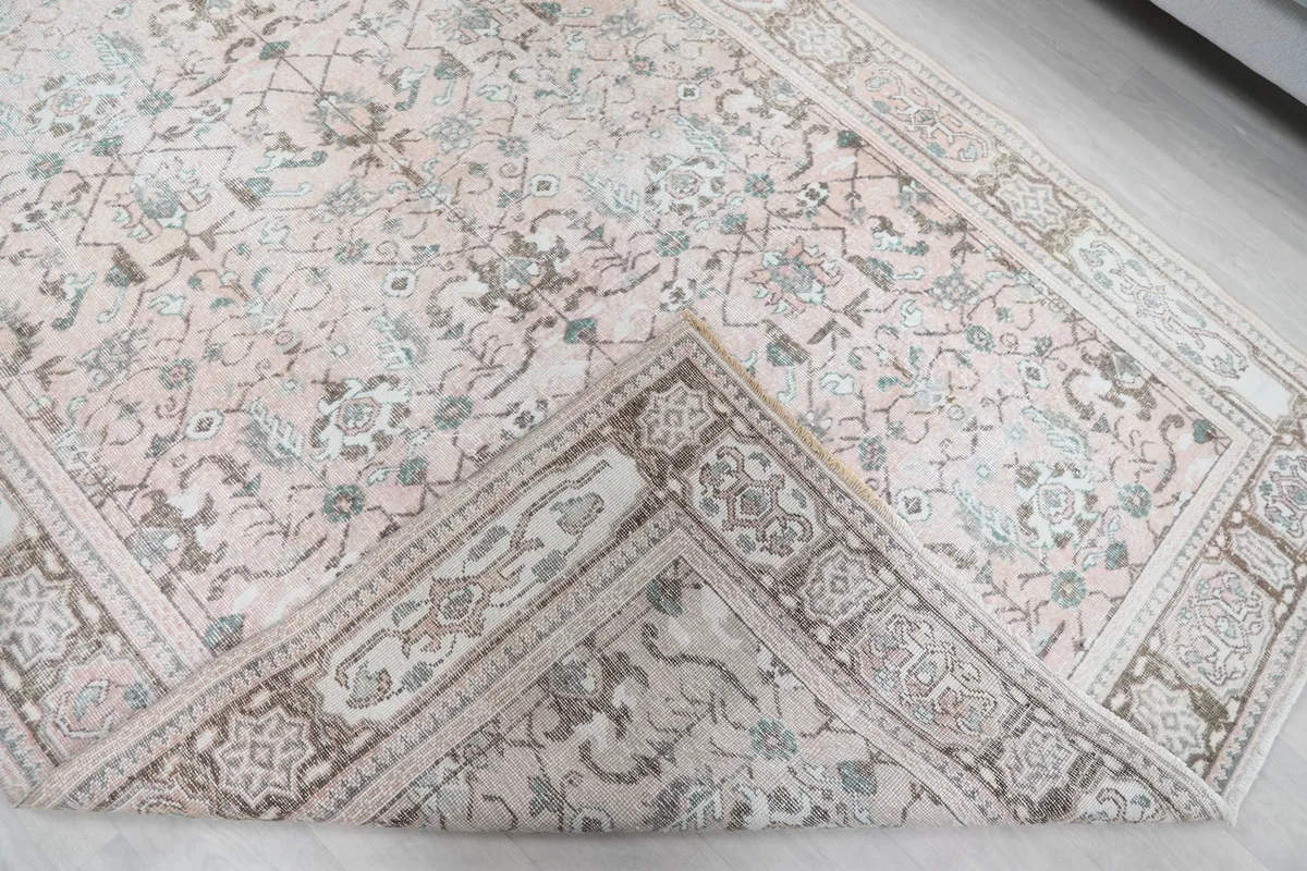 Corner of the rug folded to show the wool pile texture and backing