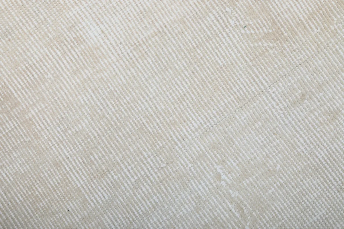 Close-up of the rug's low wool pile, showing the hand-knotted texture and natural fibers.