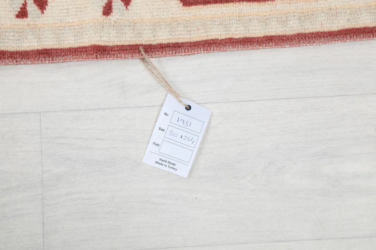 Product tag attached to the runner rug, indicating its origin and material