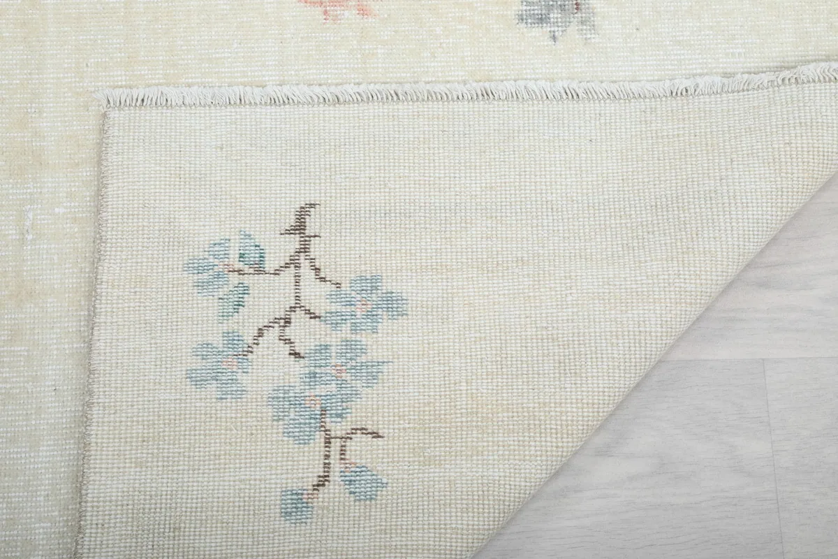 Close-up of the rug's back, showing the tight hand-knotted construction and another floral detail