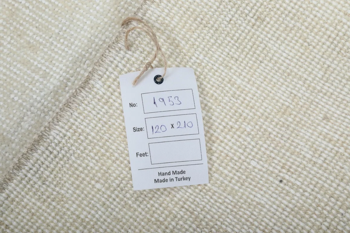 Tag on the back of the rug indicating it is hand-made in Turkey with size 120 x 210 cm