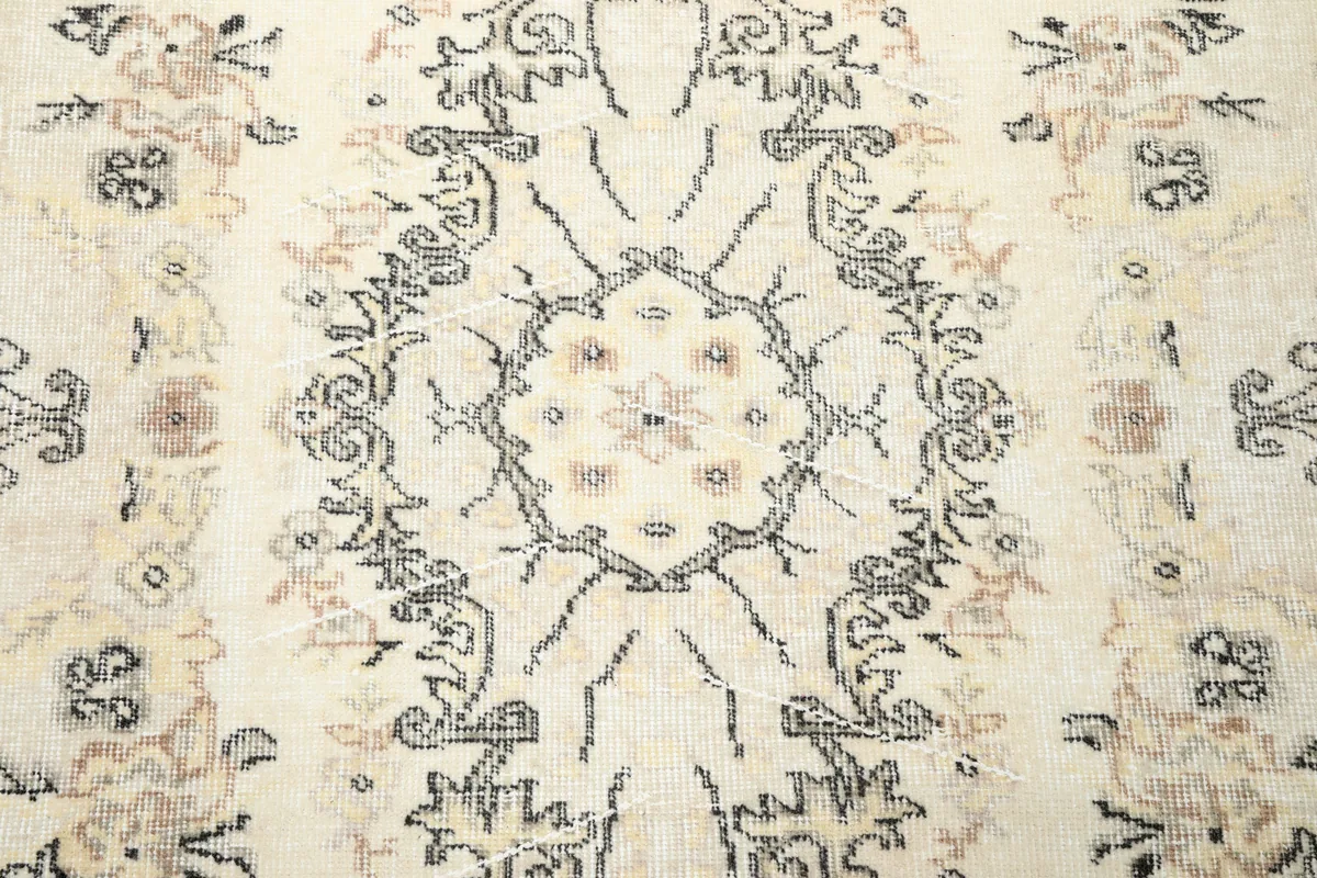 Detailed close-up of the Cream Floral Medallion Anatolian Rug's central design and faded colors