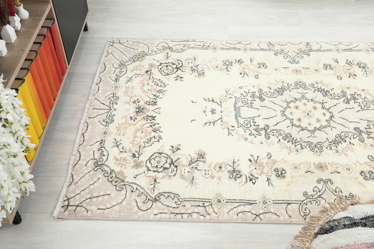 Angled view of the Cream Floral Medallion Anatolian Rug, showing its full length in a room