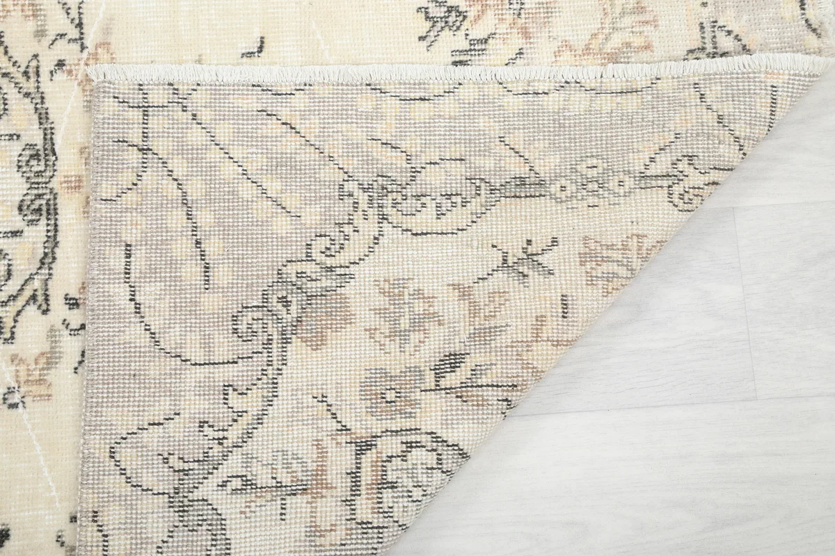 Corner view of the Cream Floral Medallion Anatolian Rug's back, showing the knotting and foundation