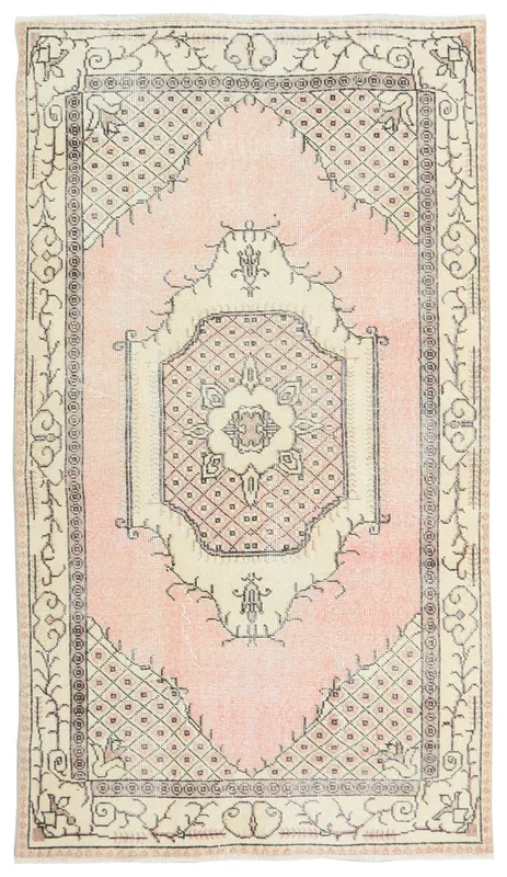 Full top view of the 3'8" x 6'5" vintage Anatolian rug with pink field and ivory medallion