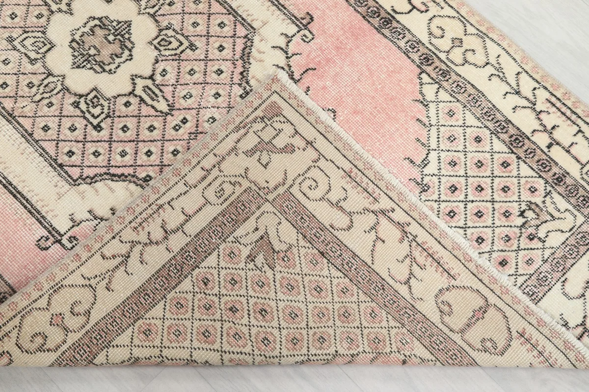 View of the underside of the rug, revealing the hand-knotted wool on cotton foundation