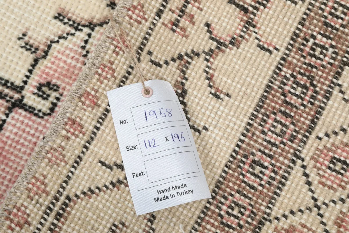 Close-up of the rug's label, indicating its hand-made origin in Turkey and size
