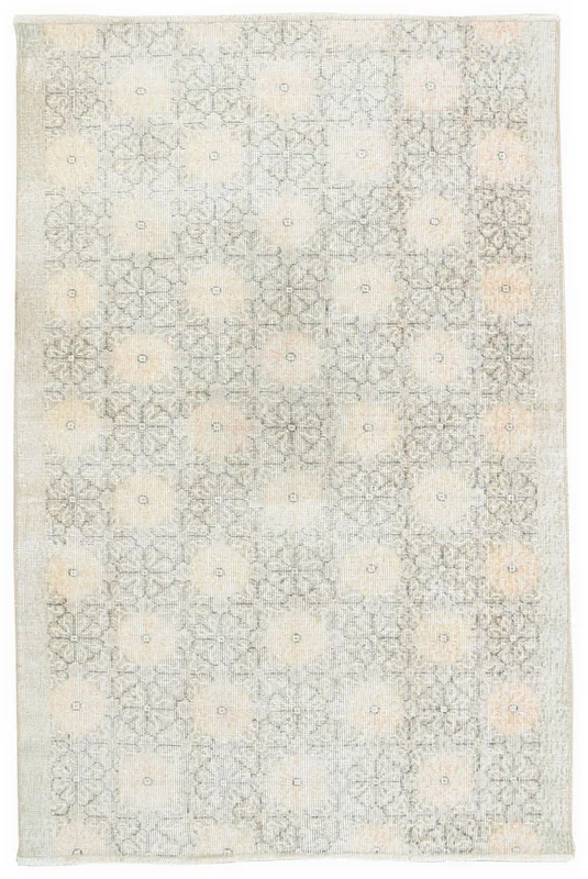 Full top view of the vintage ivory and gray geometric floral Anatolian rug on a white background.
