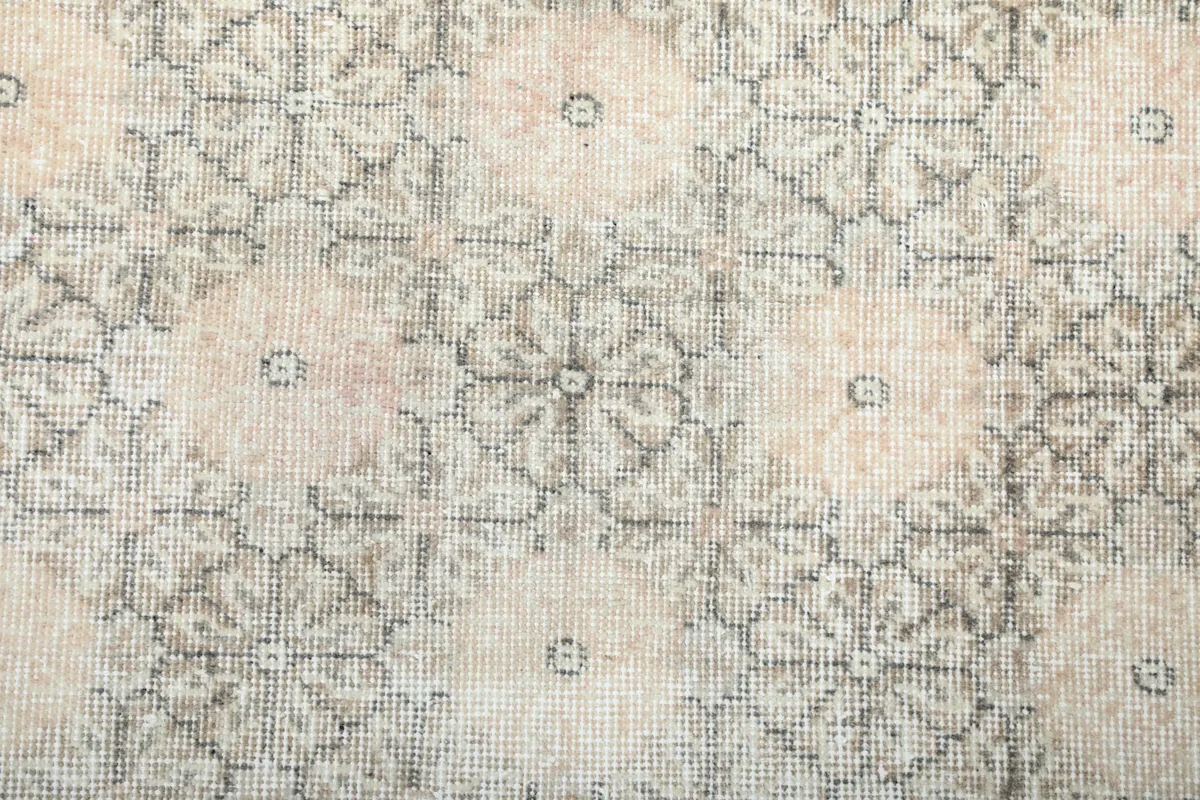 Detailed view of the hand-knotted pattern, showcasing the intricate geometric floral design and texture.