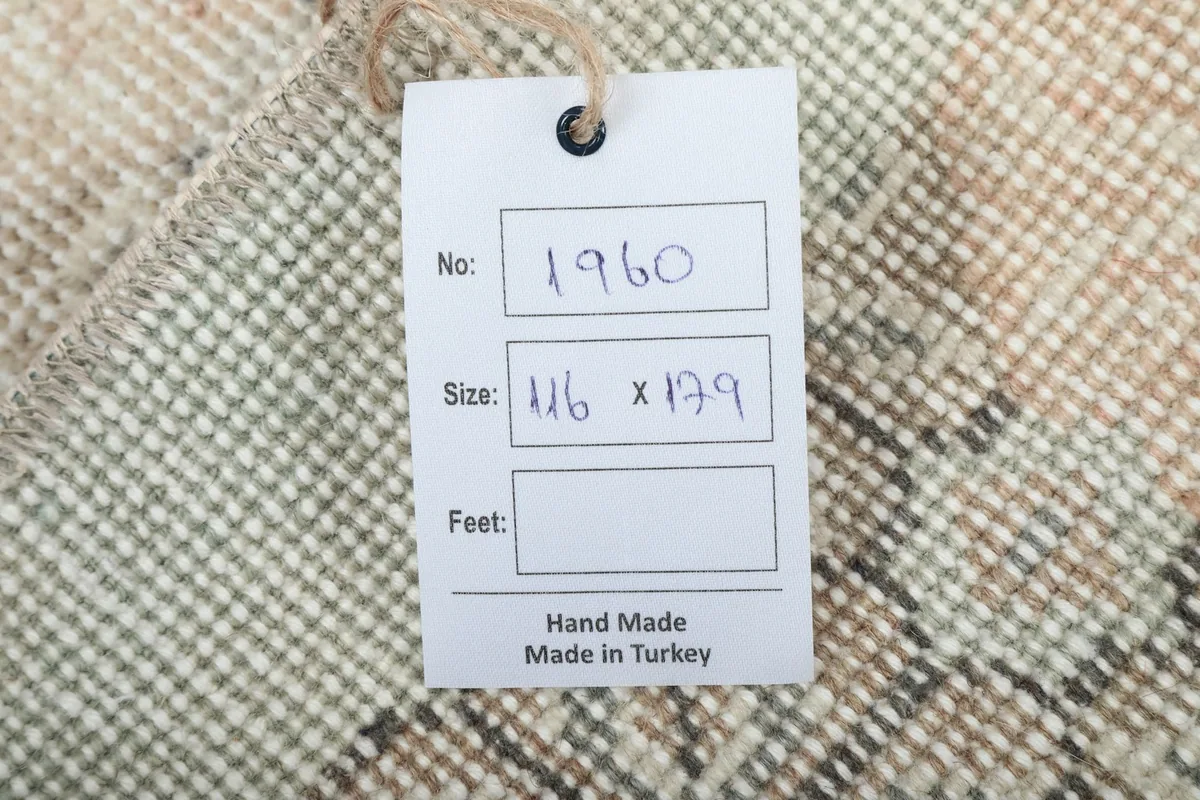 Product tag on the back of the rug, displaying item number, size in centimeters, and origin.