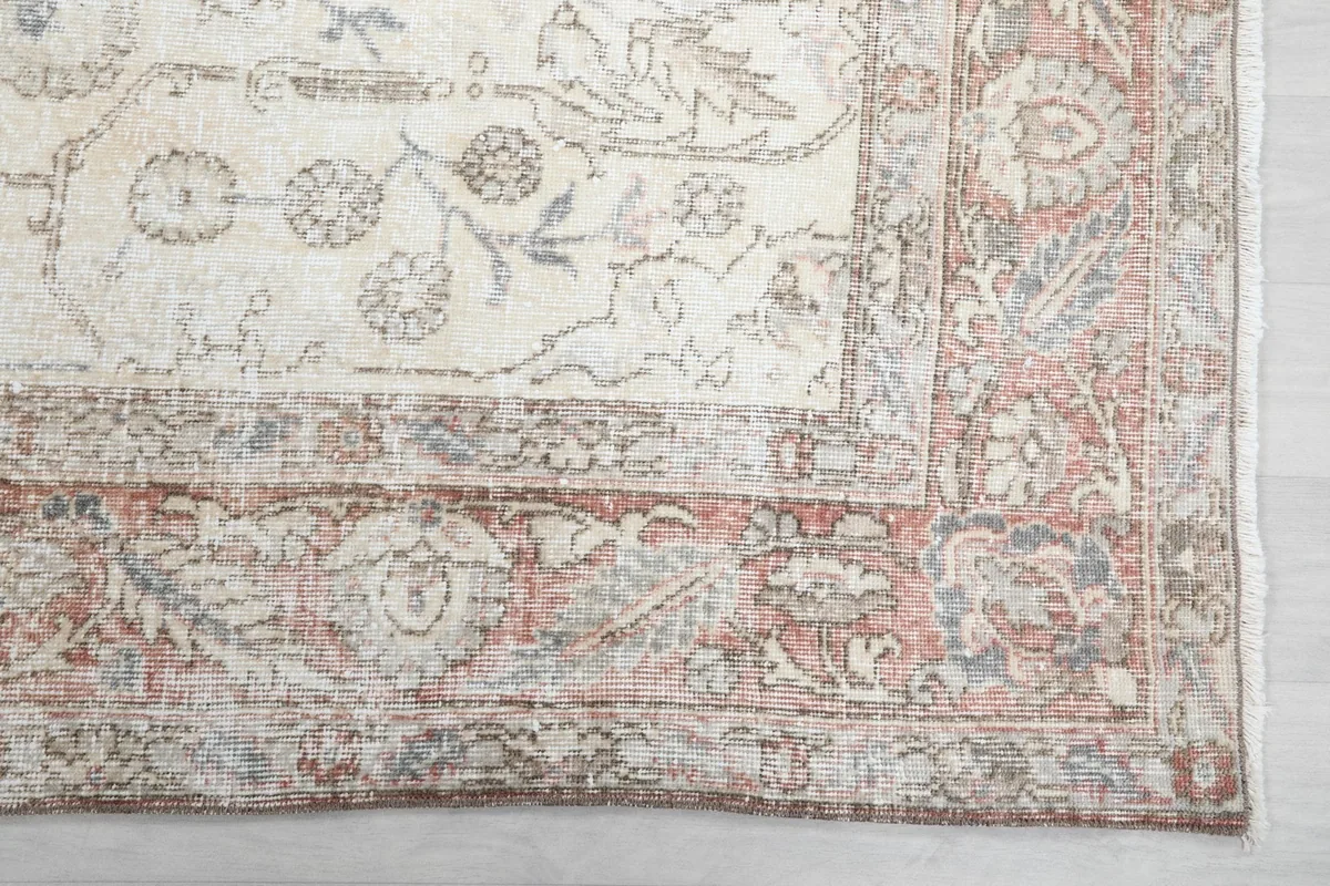 Detail of the rust colored border with traditional patterns and subtle blue accents