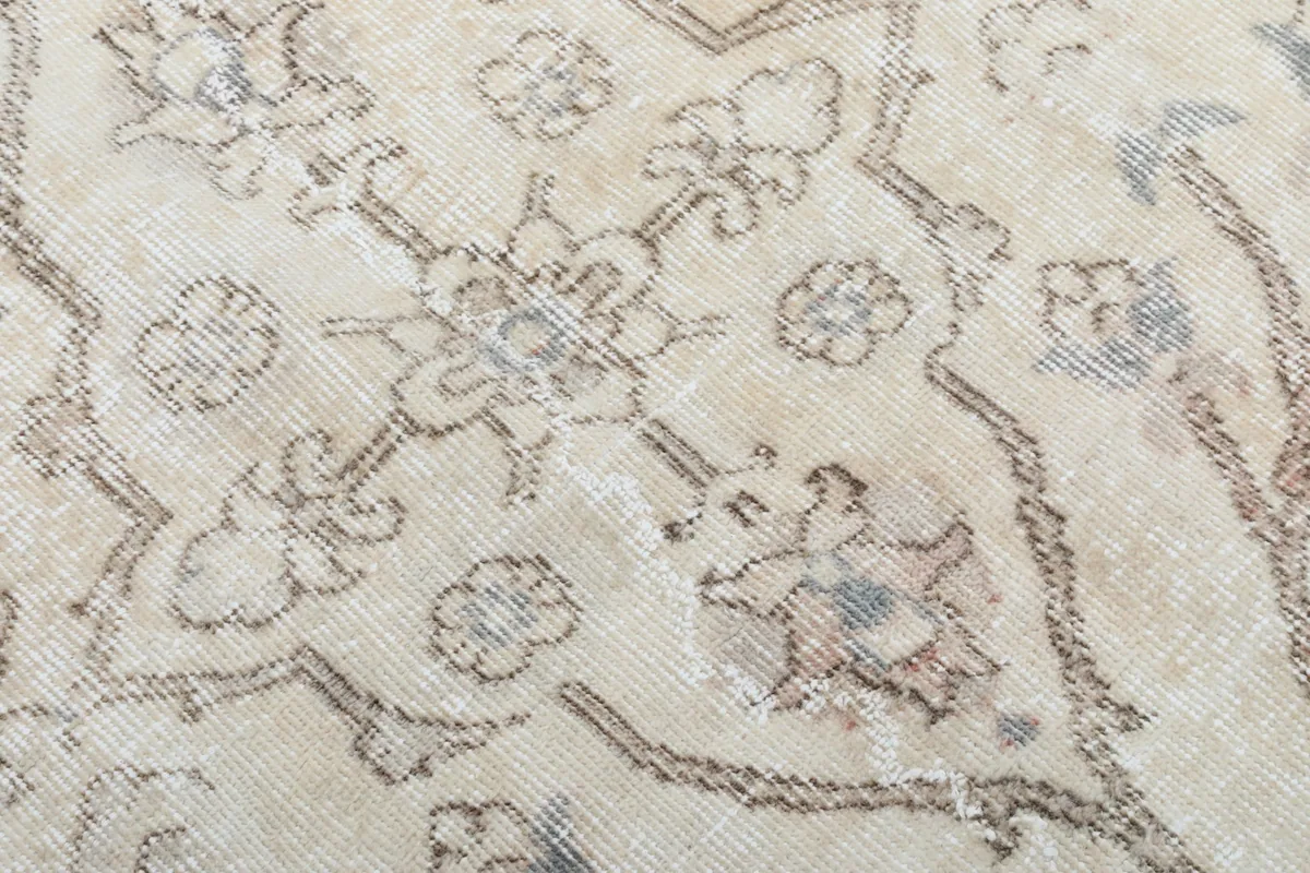 Texture and low pile of the hand-knotted wool surface with floral details