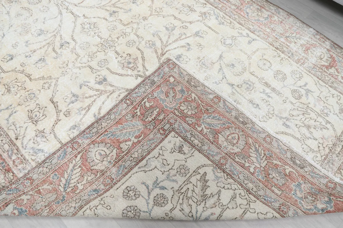Folded corner revealing the back of the hand-knotted wool rug and cotton foundation