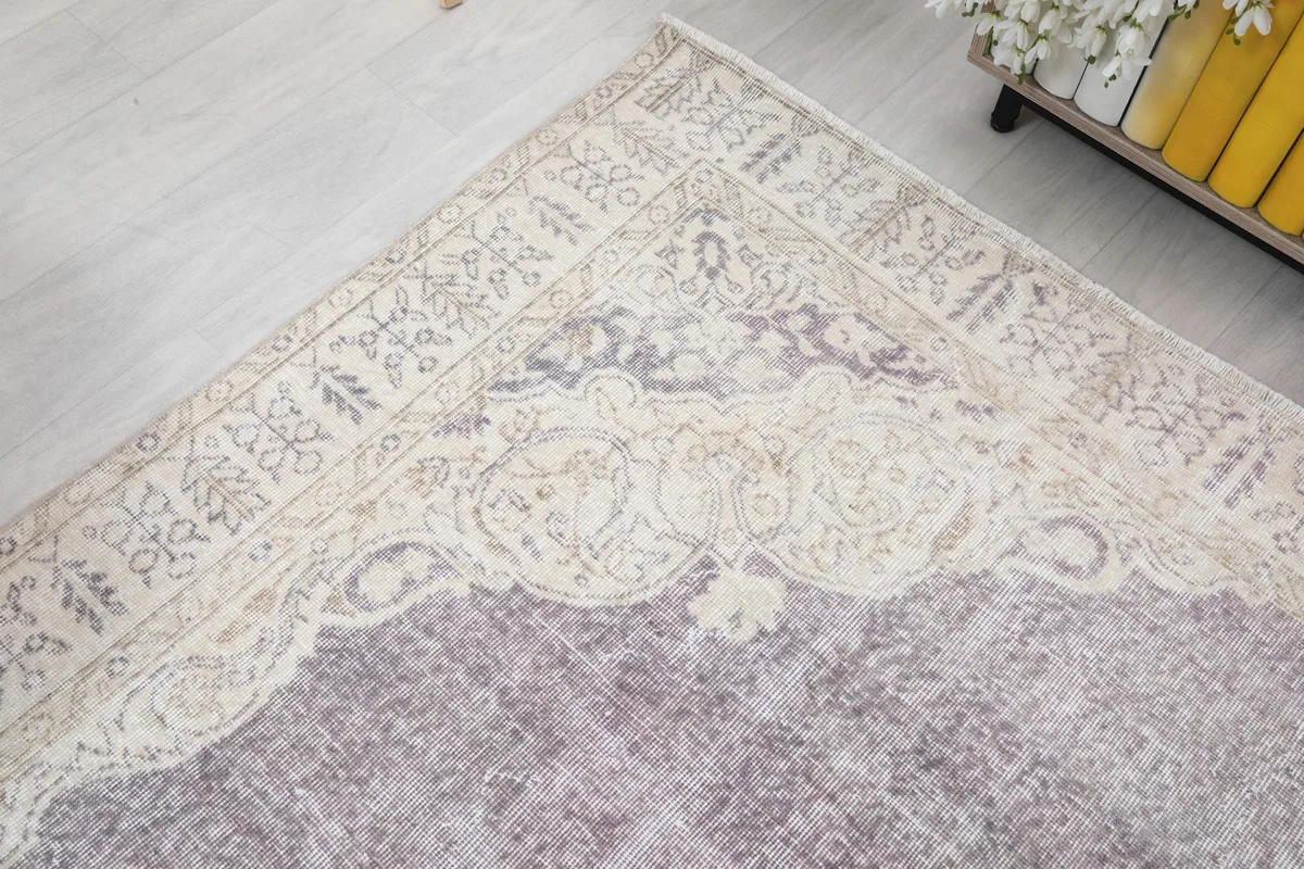 Corner view showing the rug's border design and the gentle color fade