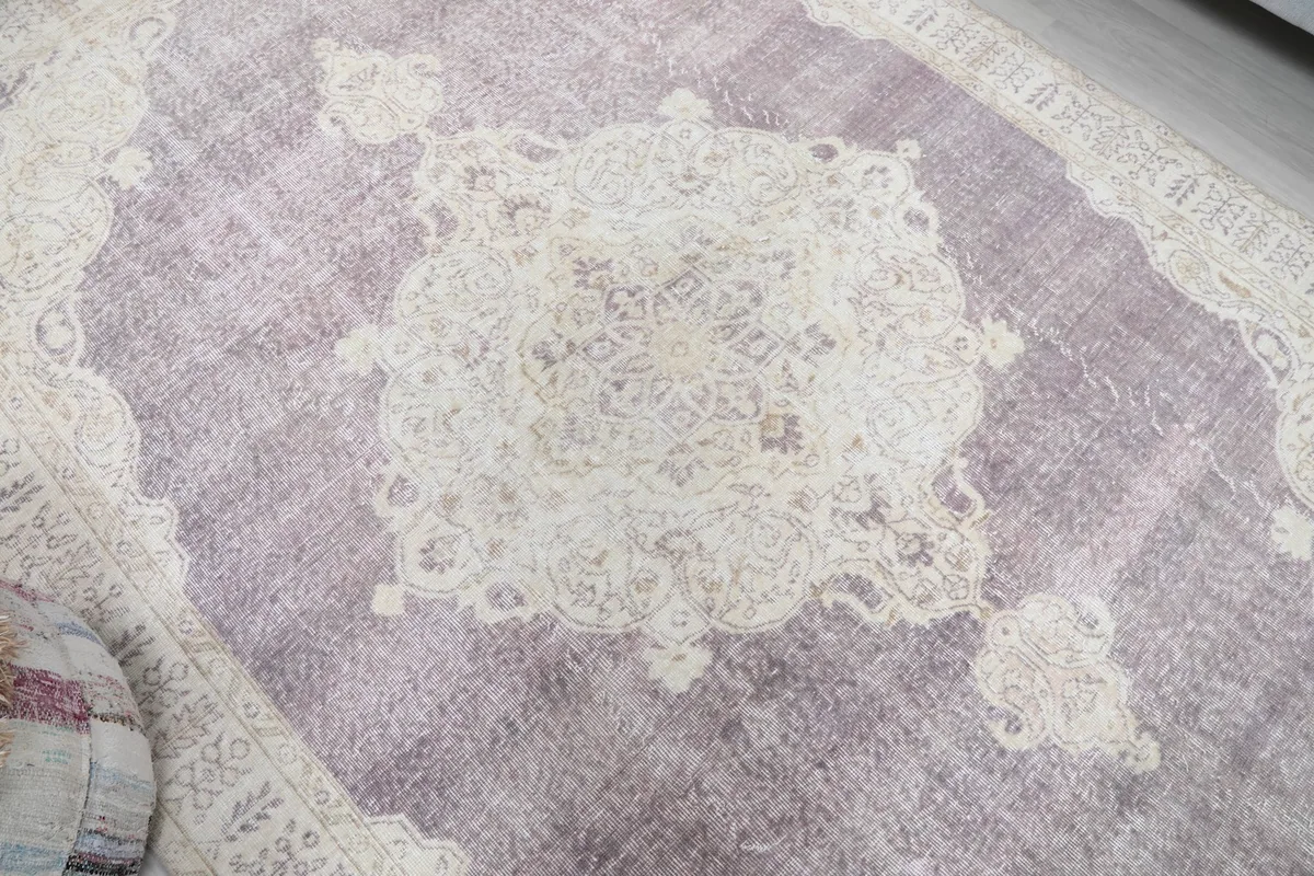 Overhead close-up of the central medallion, highlighting the faded purple and cream colors