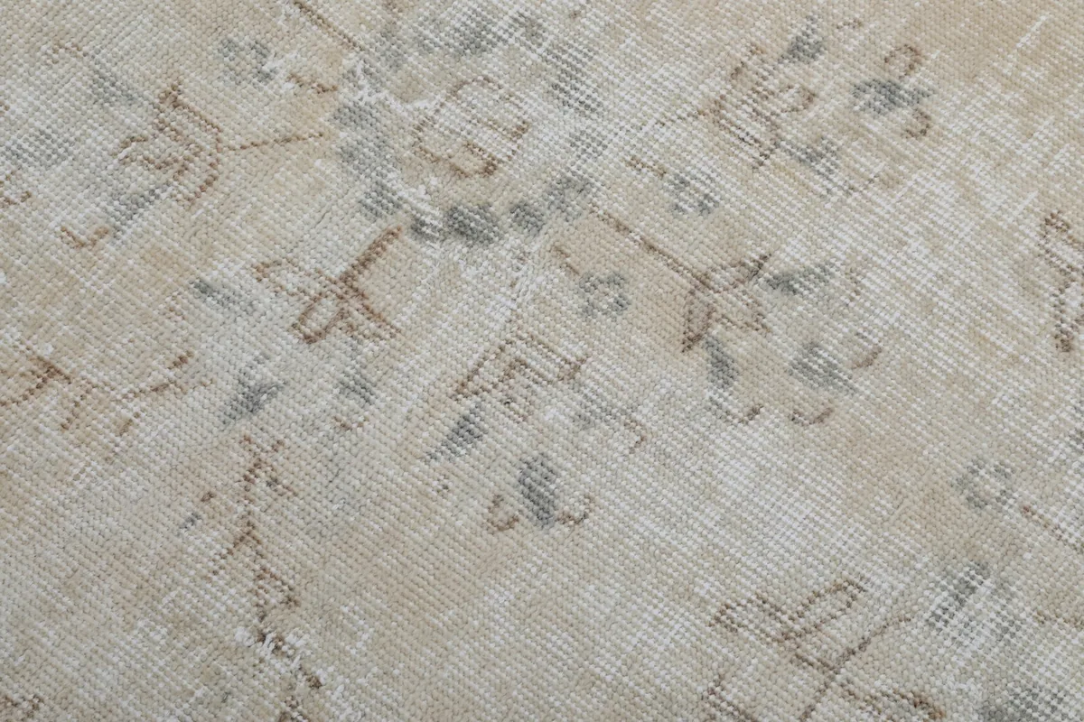 Close-up showing the low wool pile and the texture of the hand-knotted vintage rug