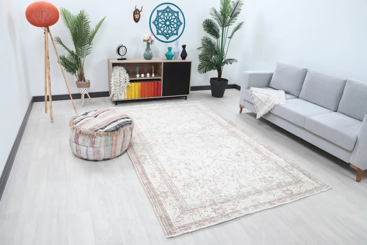 Area rug in a room with a light gray sofa and wooden cabinet, showing its scale.