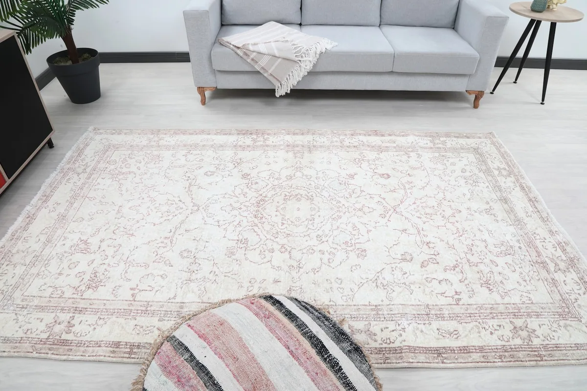 Full overhead view of the ivory and rose rug, emphasizing its overall shape and pattern.
