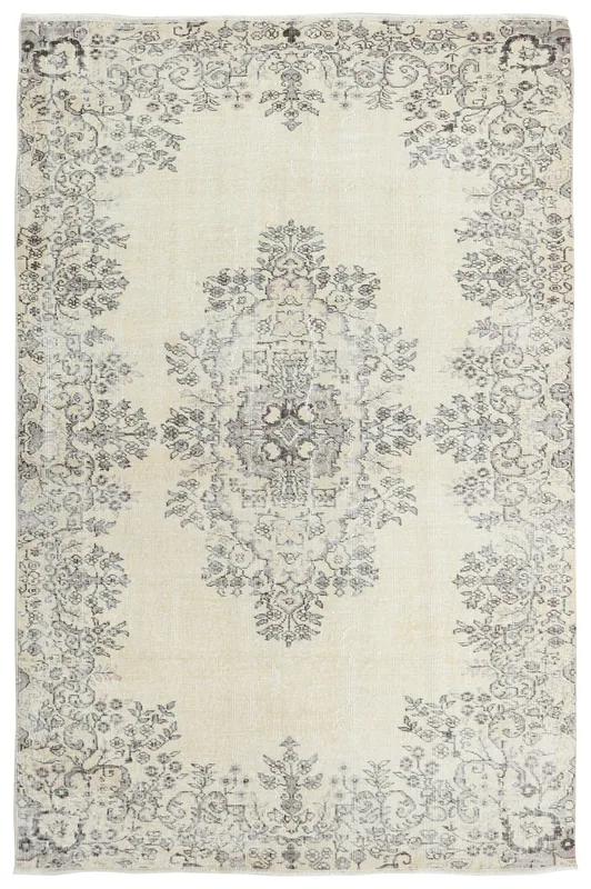 Full top view of the ivory and gray vintage Anatolian rug on a white background