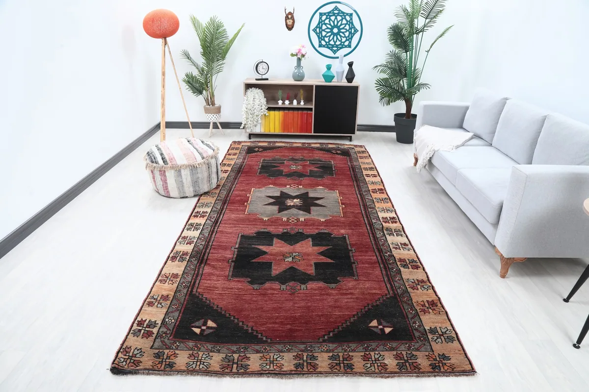 Vintage Anatolian rug displayed in a modern living room setting with a light gray sofa