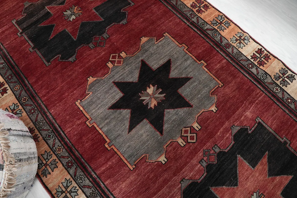 Overhead detail of the rug's central gray and black geometric star pattern