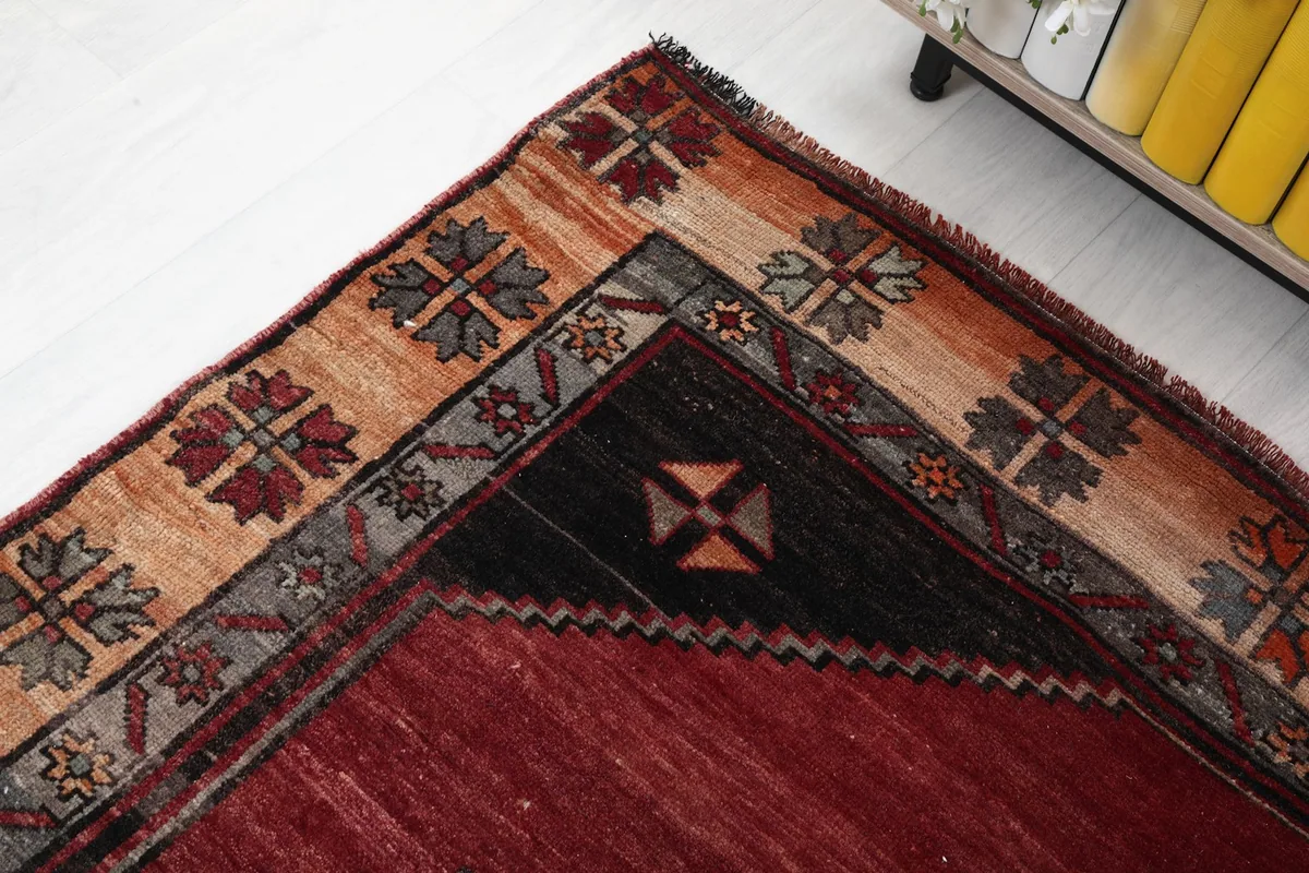 Close-up of the rug's corner, highlighting the distinct patterns in the border and field