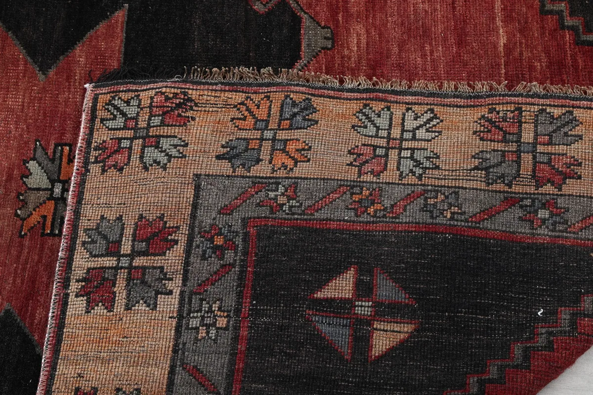 Close-up of the rug's border pattern and fringe detail