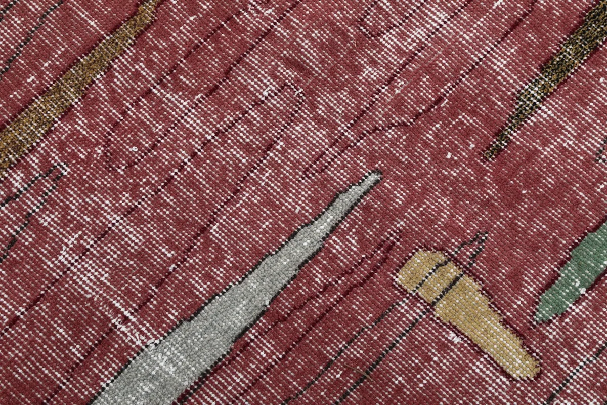 Intimate detail of the hand-knotted wool pile, showing individual knots and color variations.