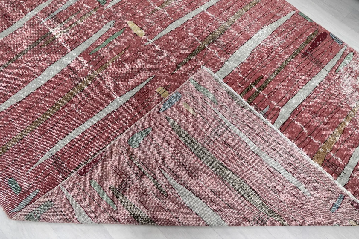 Folded corner revealing the back of the hand-knotted wool rug and the cotton foundation.