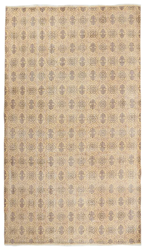 Full top view of the 7x10 tan and gray floral vintage Anatolian area rug