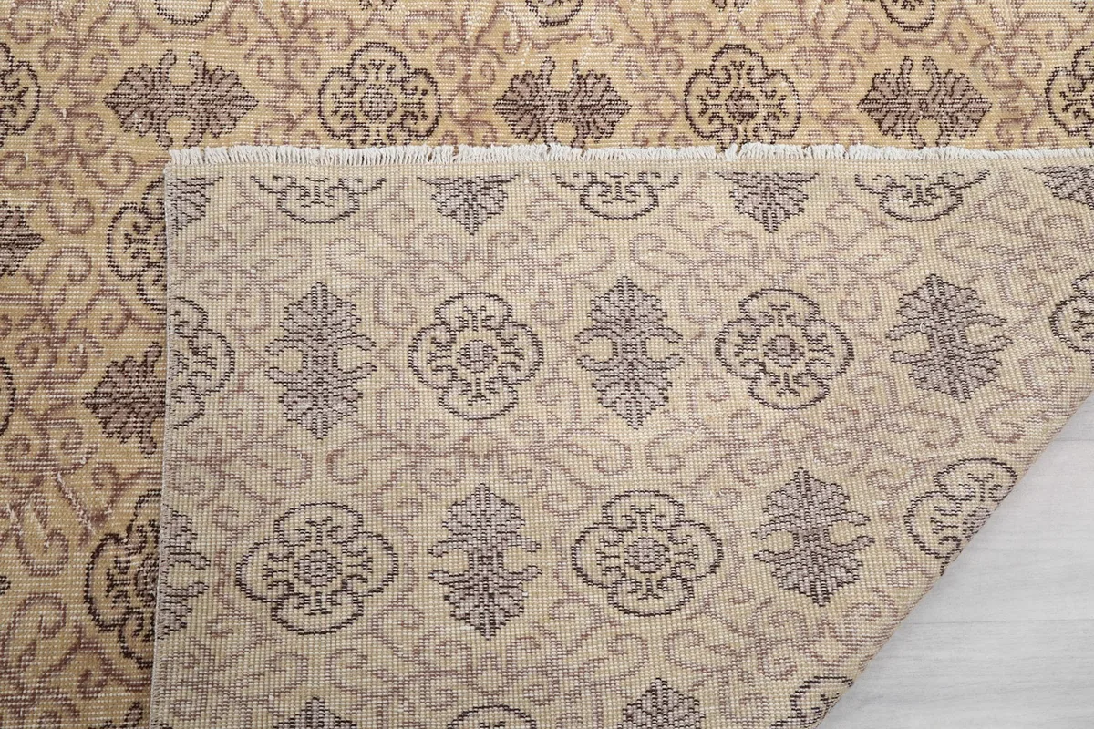 Close-up of the rug's back, showing the consistent knotting and cotton foundation