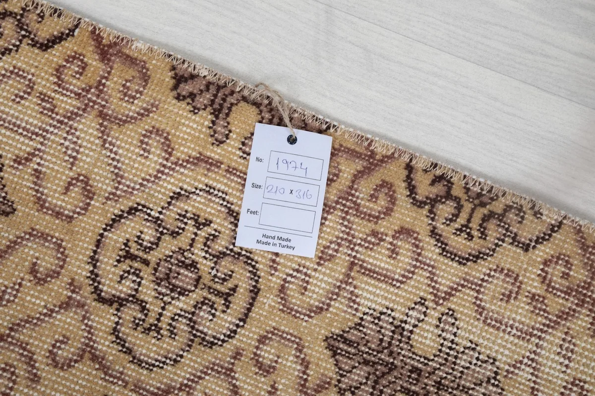 Detail of the rug's pile and a product tag with dimensions and origin information