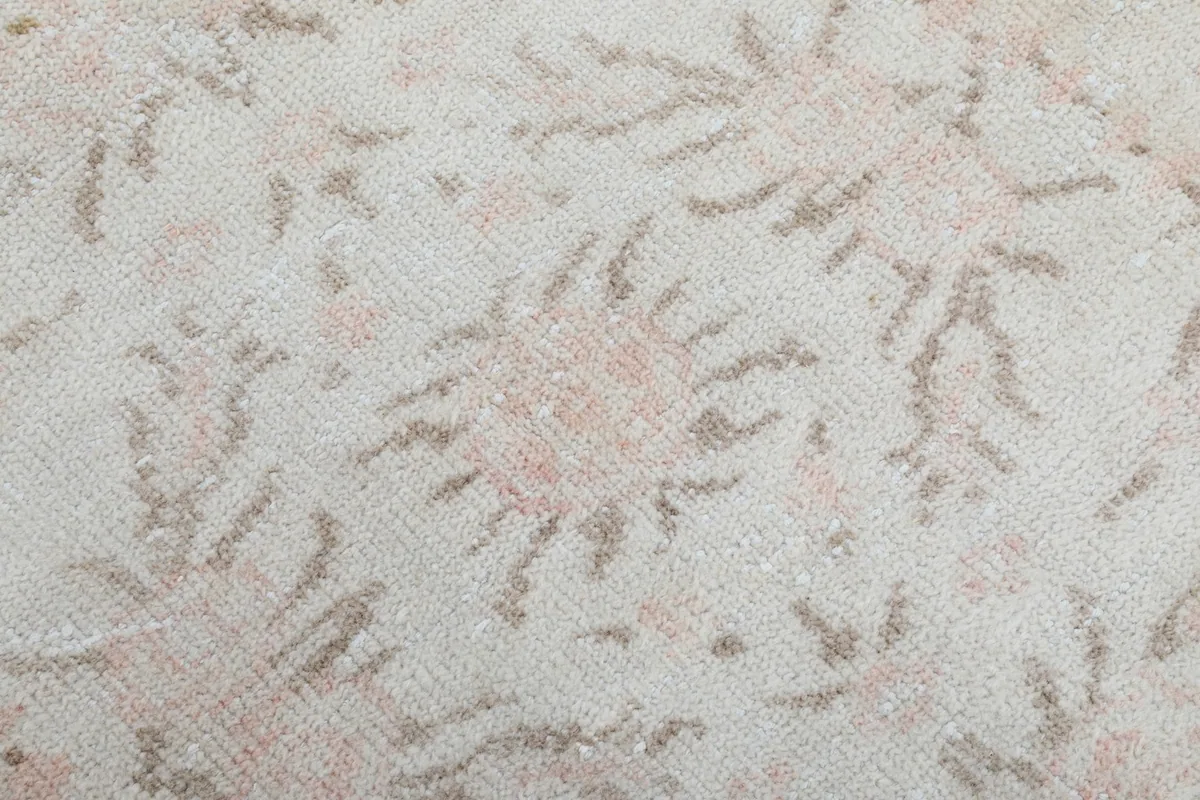 Close-up texture of the low wool pile showing subtle variations and wear