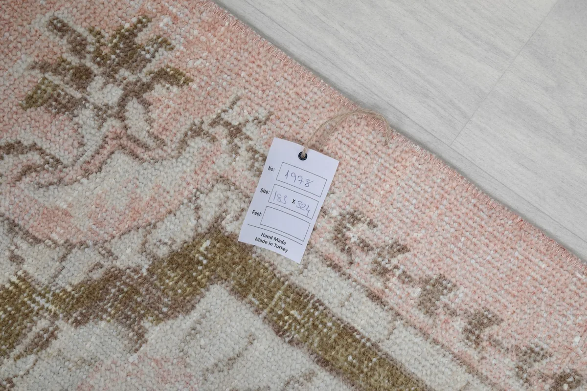 Close-up of the rug's label indicating size and origin