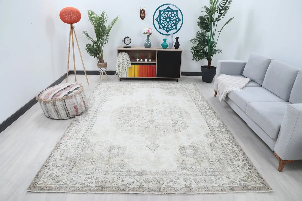 Ivory and gray vintage rug displayed in a bright living room setting with modern furniture