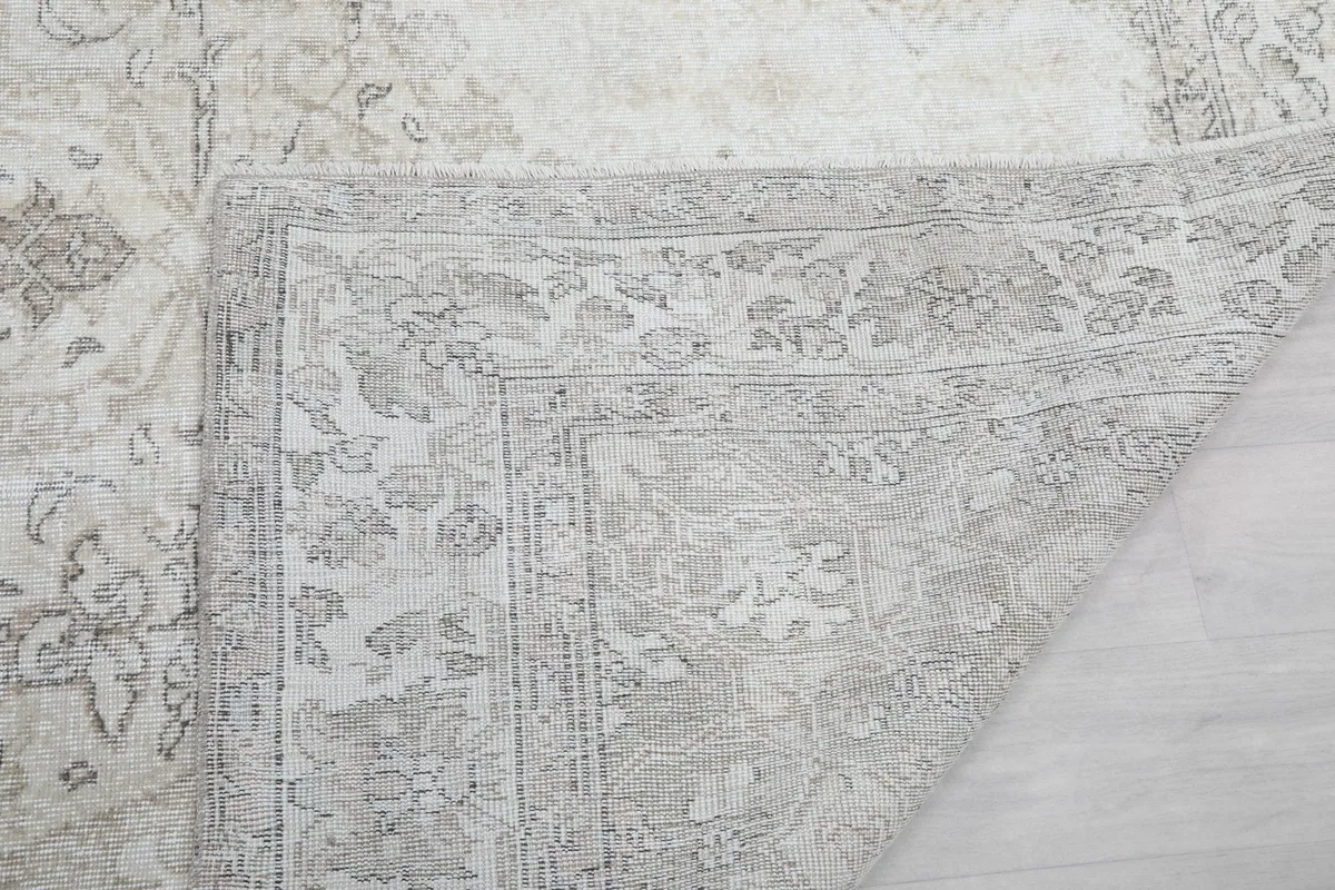 Another view of the rug's underside, revealing the tightly woven cotton foundation and knot work