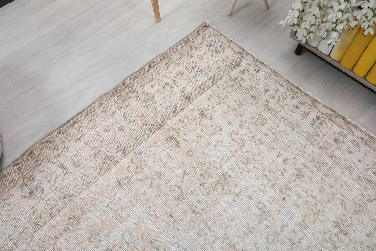 Detailed shot of a corner of the rug, emphasizing the intricate border design and corner motifs.