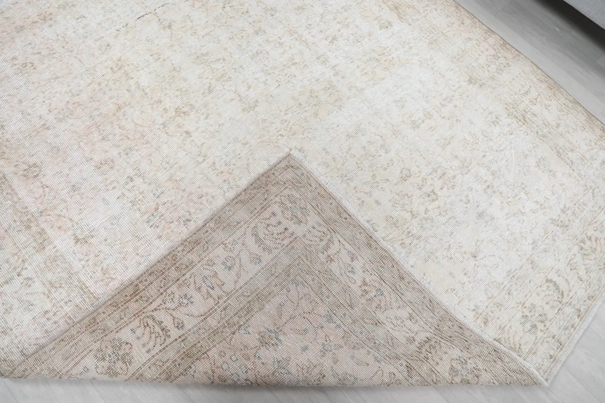 View of the rug's underside, revealing the hand-knotted cotton foundation and craftsmanship.