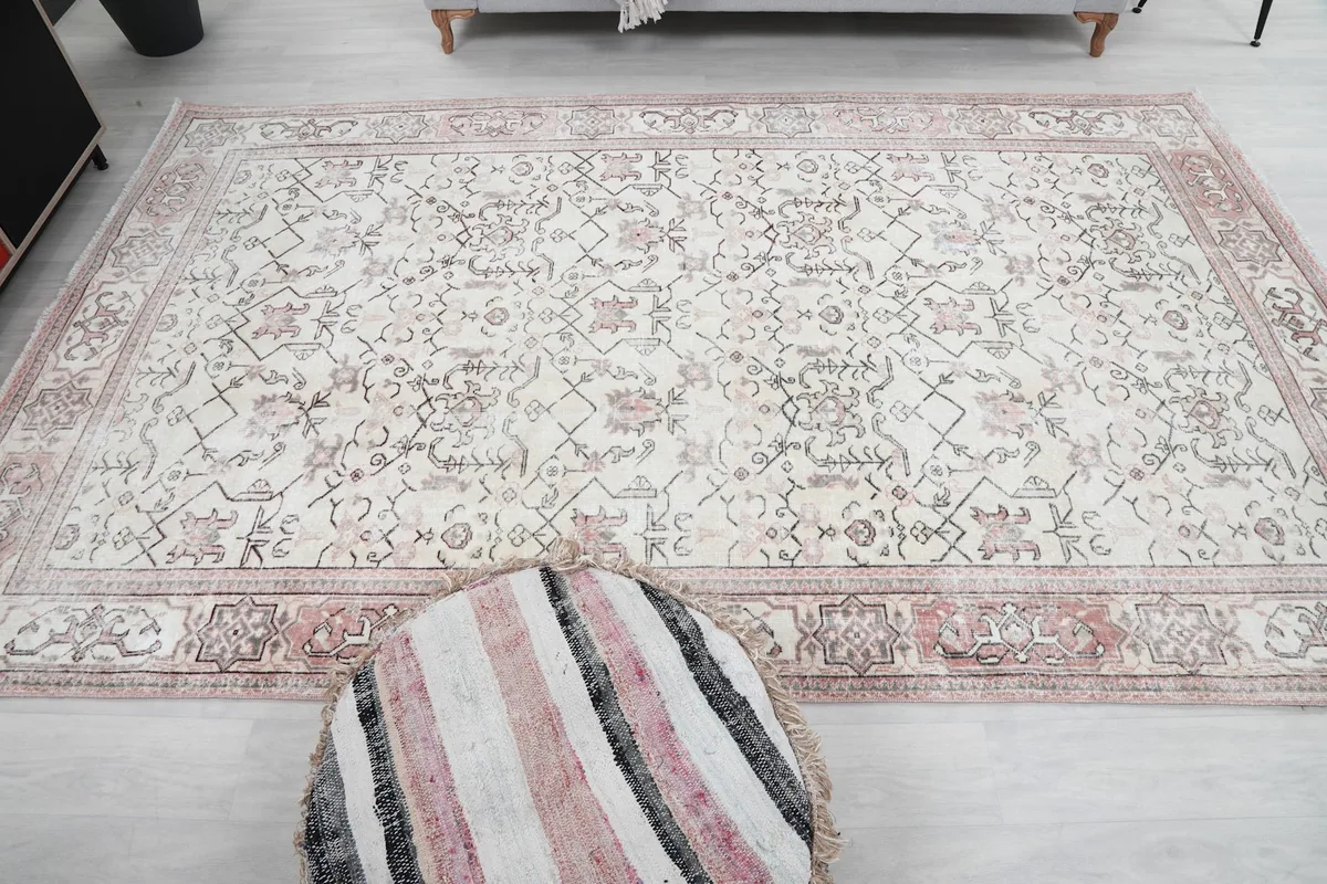 Wide shot of the rug laid out in a room, emphasizing its large size and presence