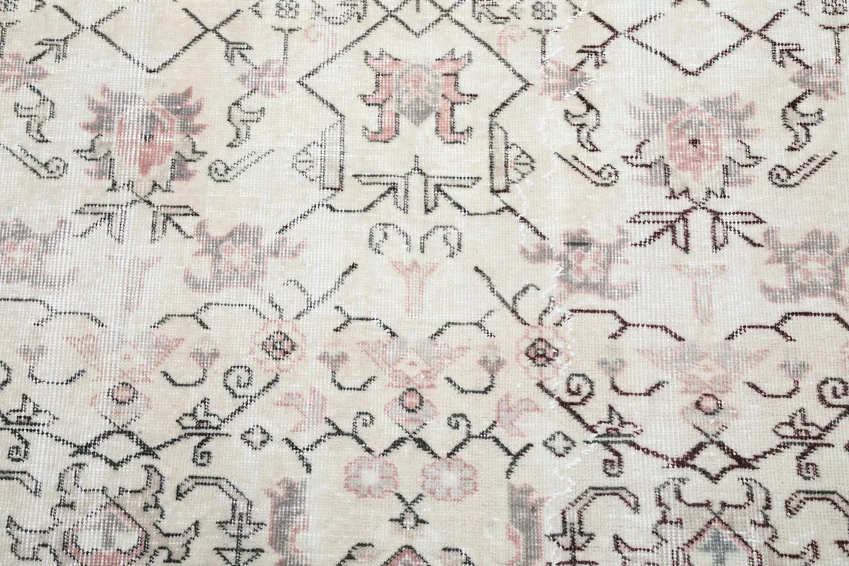 Close-up of the rug's main field pattern, highlighting the weave and color variations