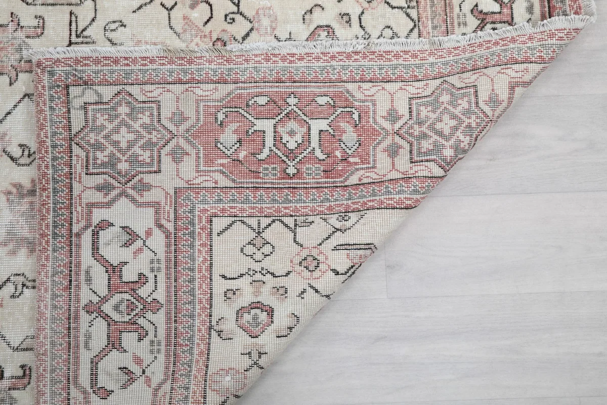 View of the rug's reverse side, showing the hand-knotted cotton foundation