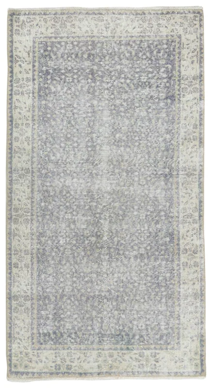 Full overhead view of the 4x7 gray floral vintage Anatolian area rug on a white background