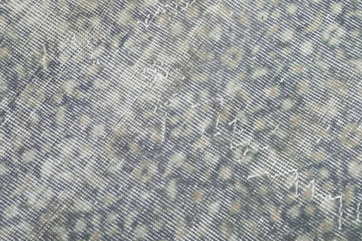 Close-up detail of the hand-knotted wool pile showing the texture and subtle color variations