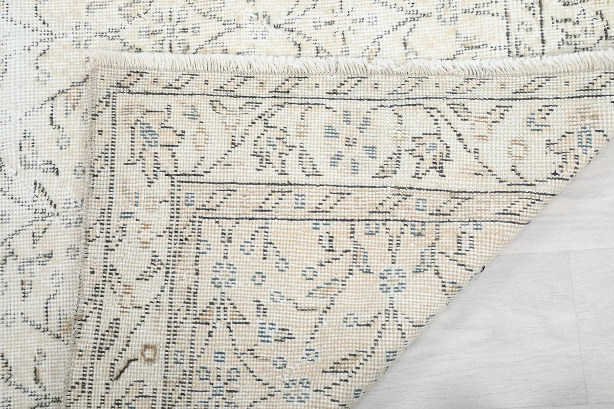 Close-up of the reverse side of the rug, showing the hand-knotted cotton foundation