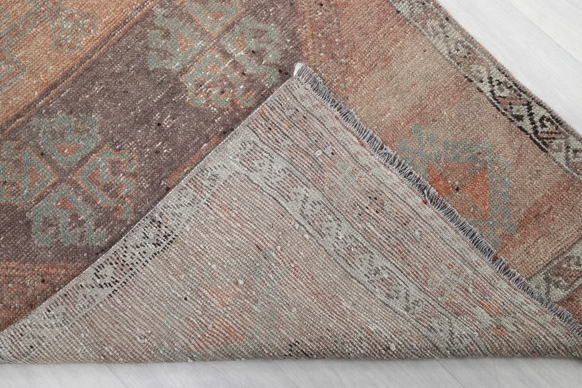 Underside of the rug, showing the cotton foundation and hand-knotted construction